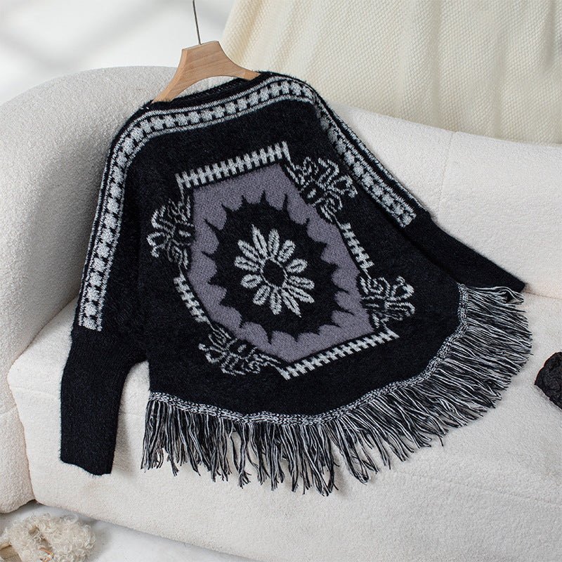 Ladies elegant knitted poncho with artistic pattern and fringed hem