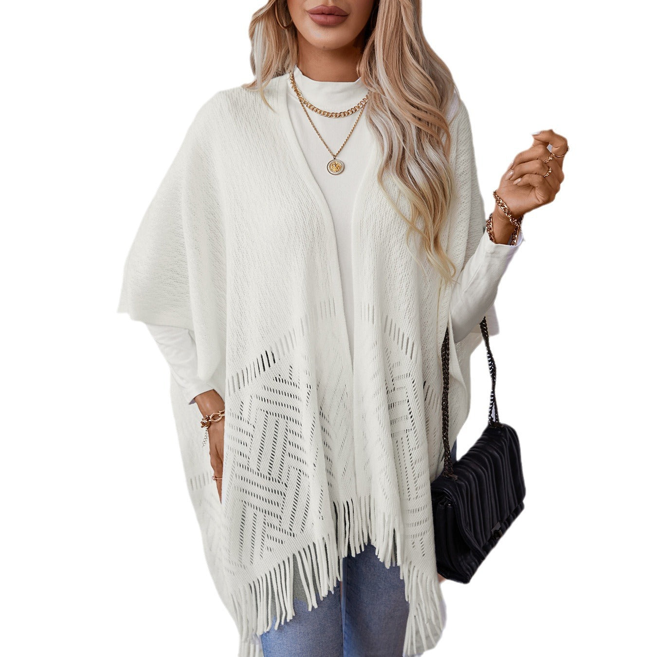 Ladies elegant knitted poncho with fringed details and striking pattern