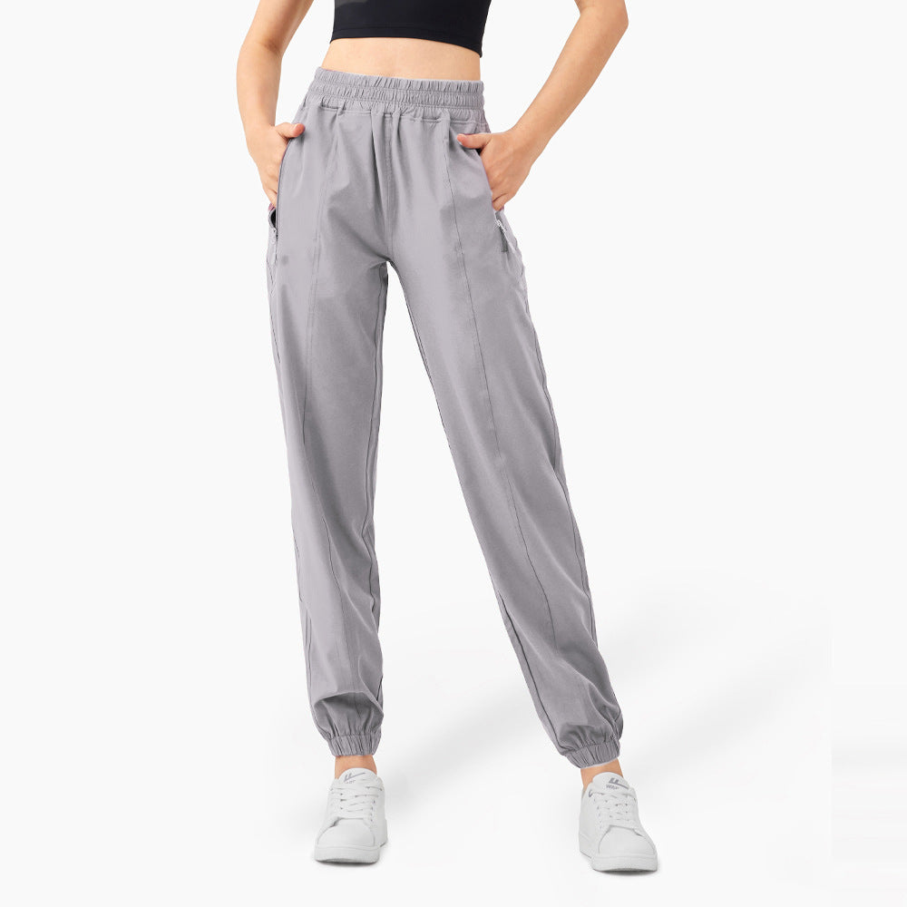 Ladies sporty jogging pants with elastic waistband and side zip pockets
