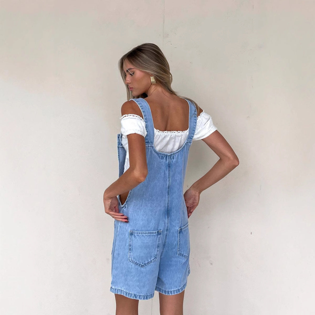 Women's denim overalls with practical pockets and button-down design