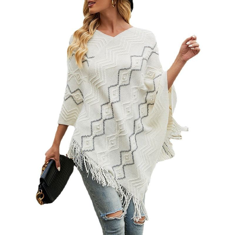 Ladies elegant poncho with eye-catching textured pattern and decorative fringes