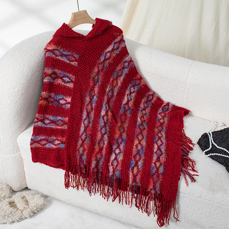 Ladies knit poncho with hood and fringed design