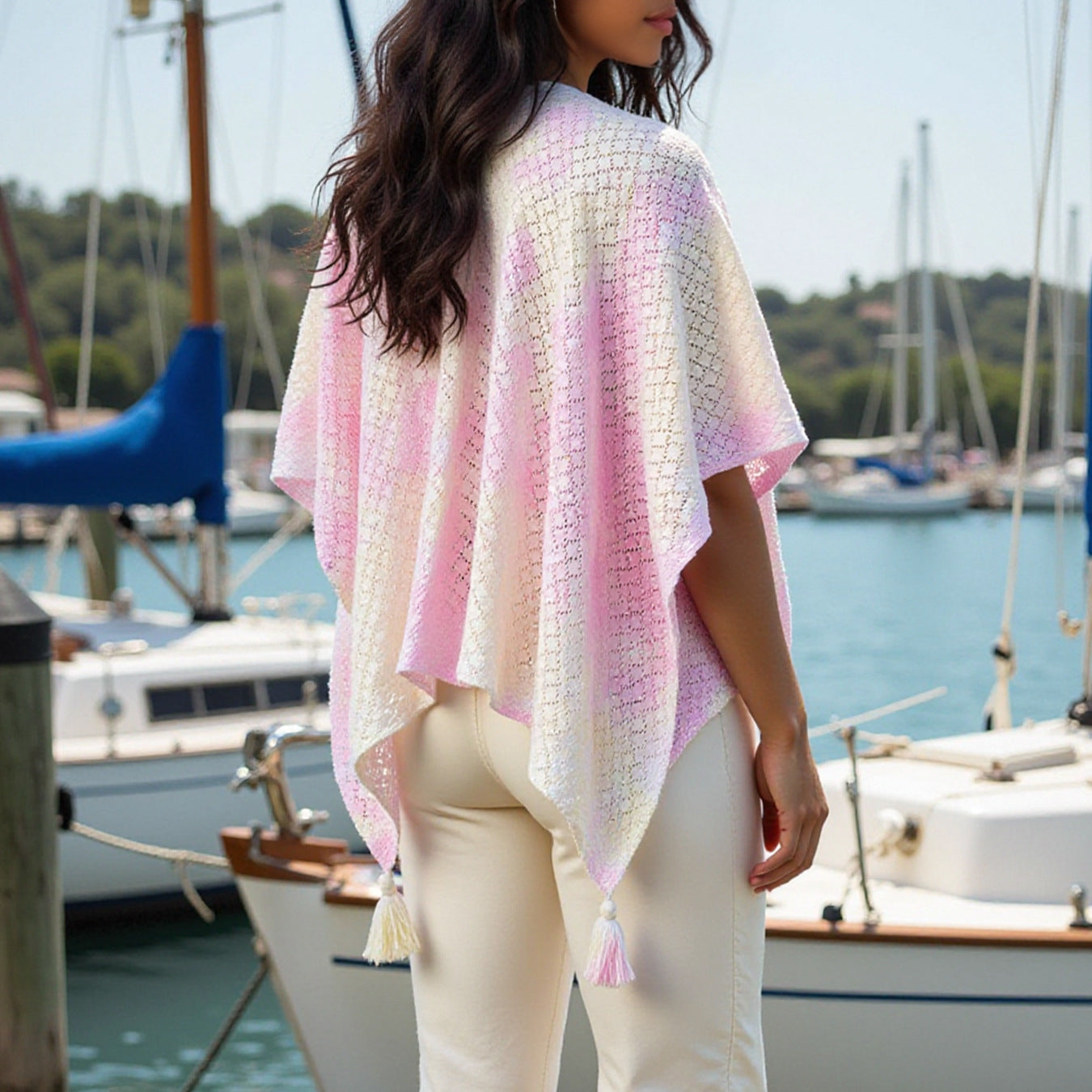 Ladies airy knitted poncho with decorative tassels