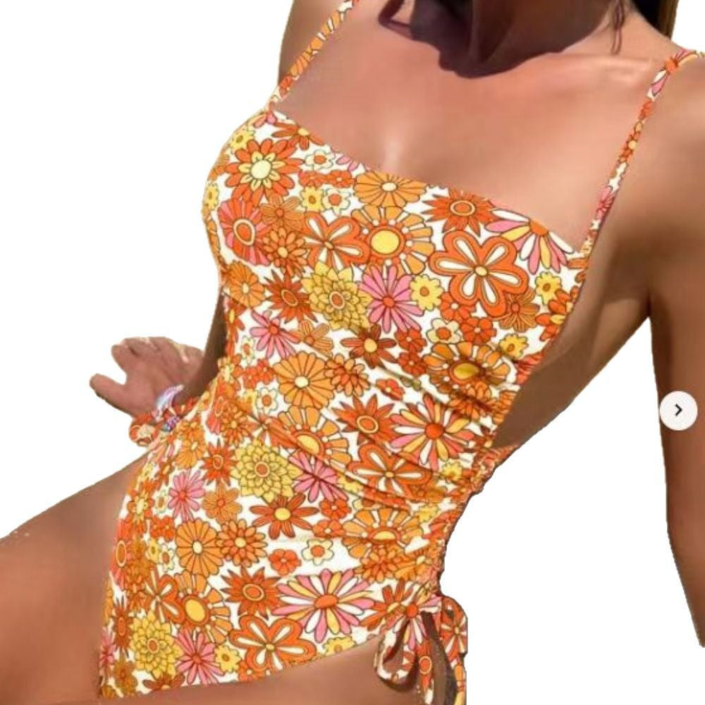 Women's one-piece swimsuit with playful floral design and adjustable cut