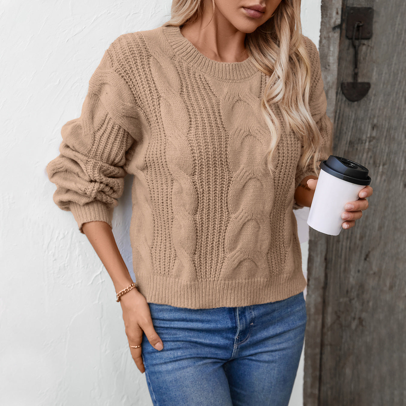 Women's chunky knit pullover with voluminous sleeves and cable pattern