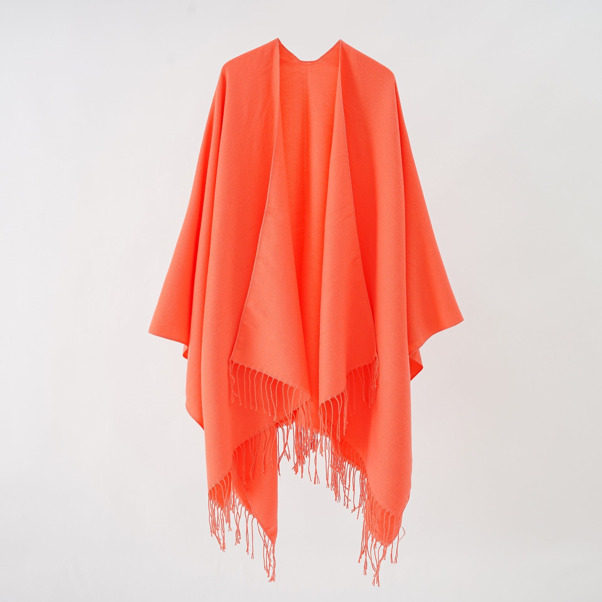 Women's stylish fringe poncho made from soft material with a luxurious drape