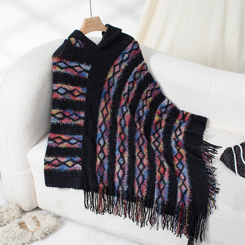 Ladies knit poncho with hood and fringed design
