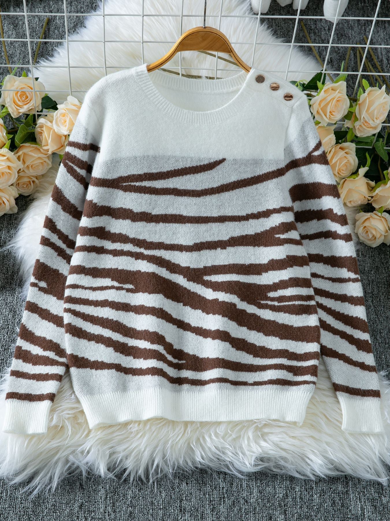 Ladies cozy knitted pullover with modern zebra stripe pattern and comfortable fit