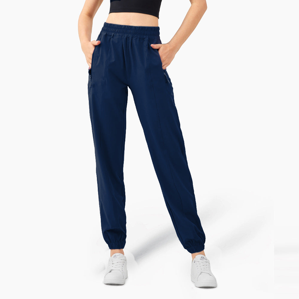 Ladies sporty jogging pants with elastic waistband and side zip pockets