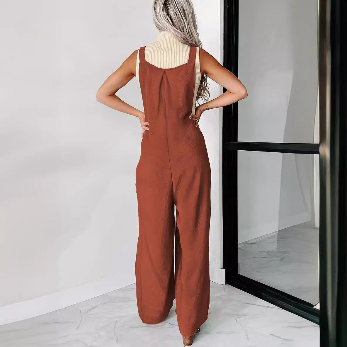 Women’s casual jumpsuit with wide cut legs and decorative button details