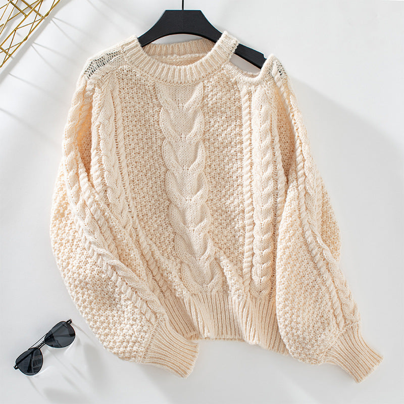 Women's chunky knit pullover with elegant structure and trendy puff sleeves
