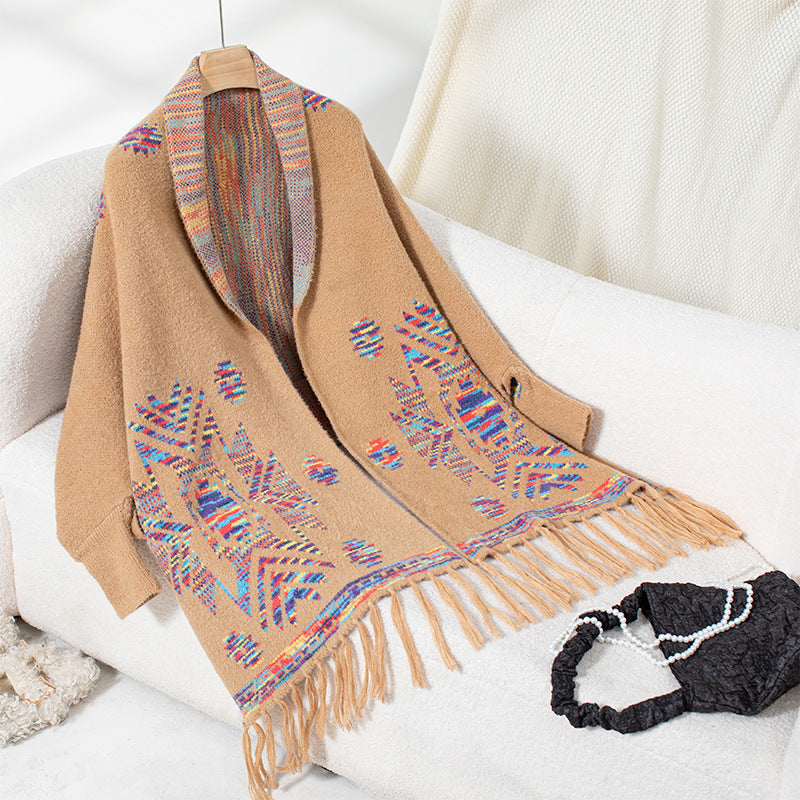 Women’s knitted poncho with colorful Navajo pattern and fringed hem