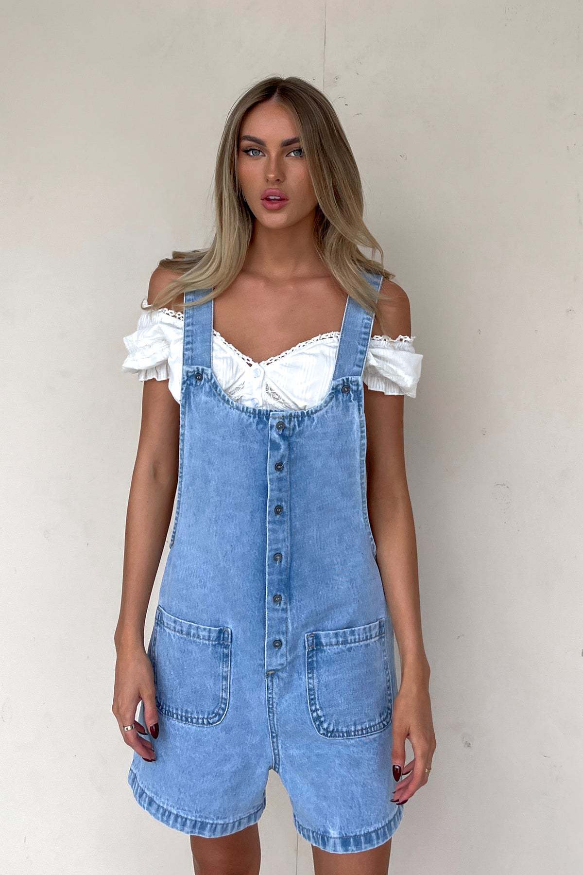 Women's denim overalls with practical pockets and button-down design