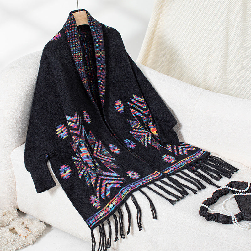 Women’s knitted poncho with colorful Navajo pattern and fringed hem