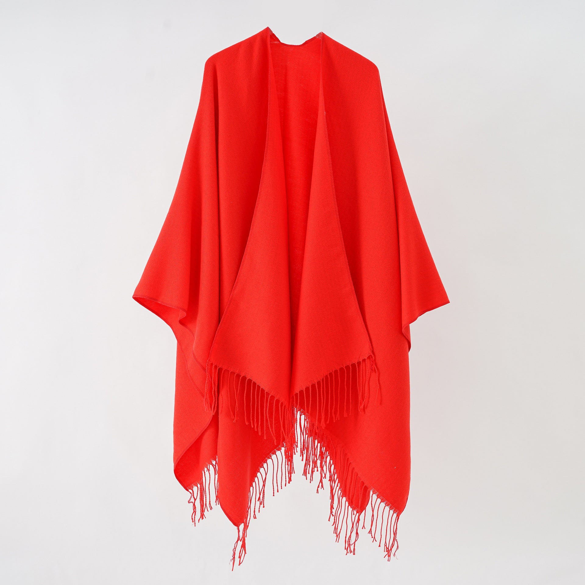 Women's stylish fringe poncho made from soft material with a luxurious drape