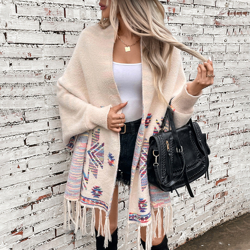 Women’s knitted poncho with colorful Navajo pattern and fringed hem