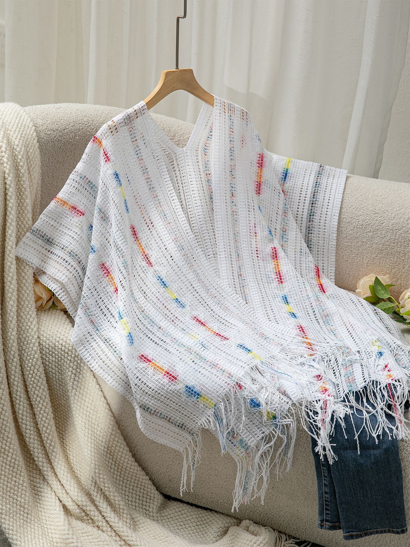 Women’s casual poncho with fringed details and colorful patterns