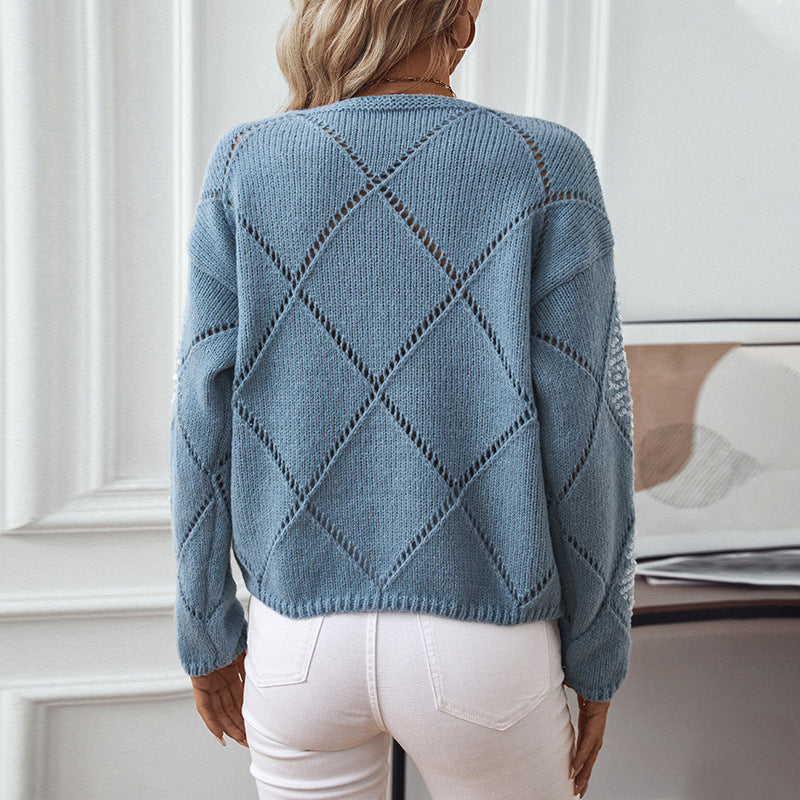 Ladies fashionable pullover with intricate knit design and glitter elements