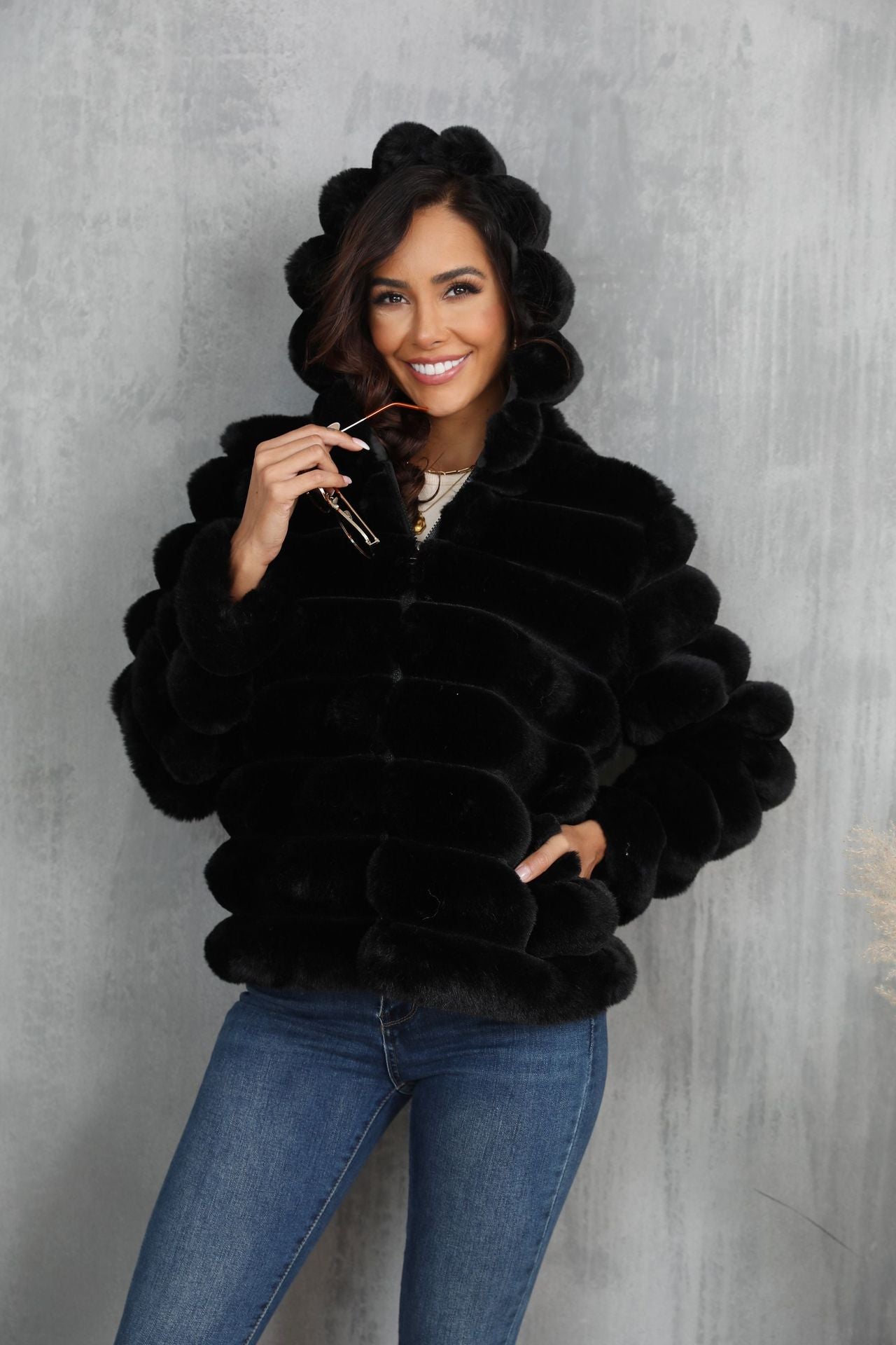 Women's stylish hooded jacket made of faux fur with a textured pattern