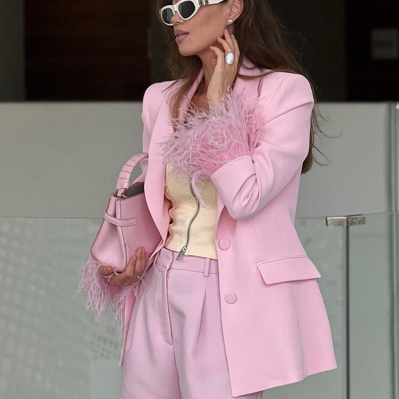 Women's elegant blazer with striking feather sleeves