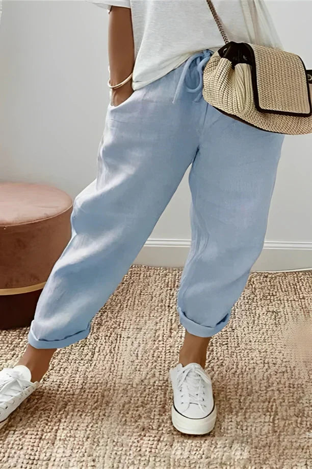 Pants with drawstring and diagonal pocket